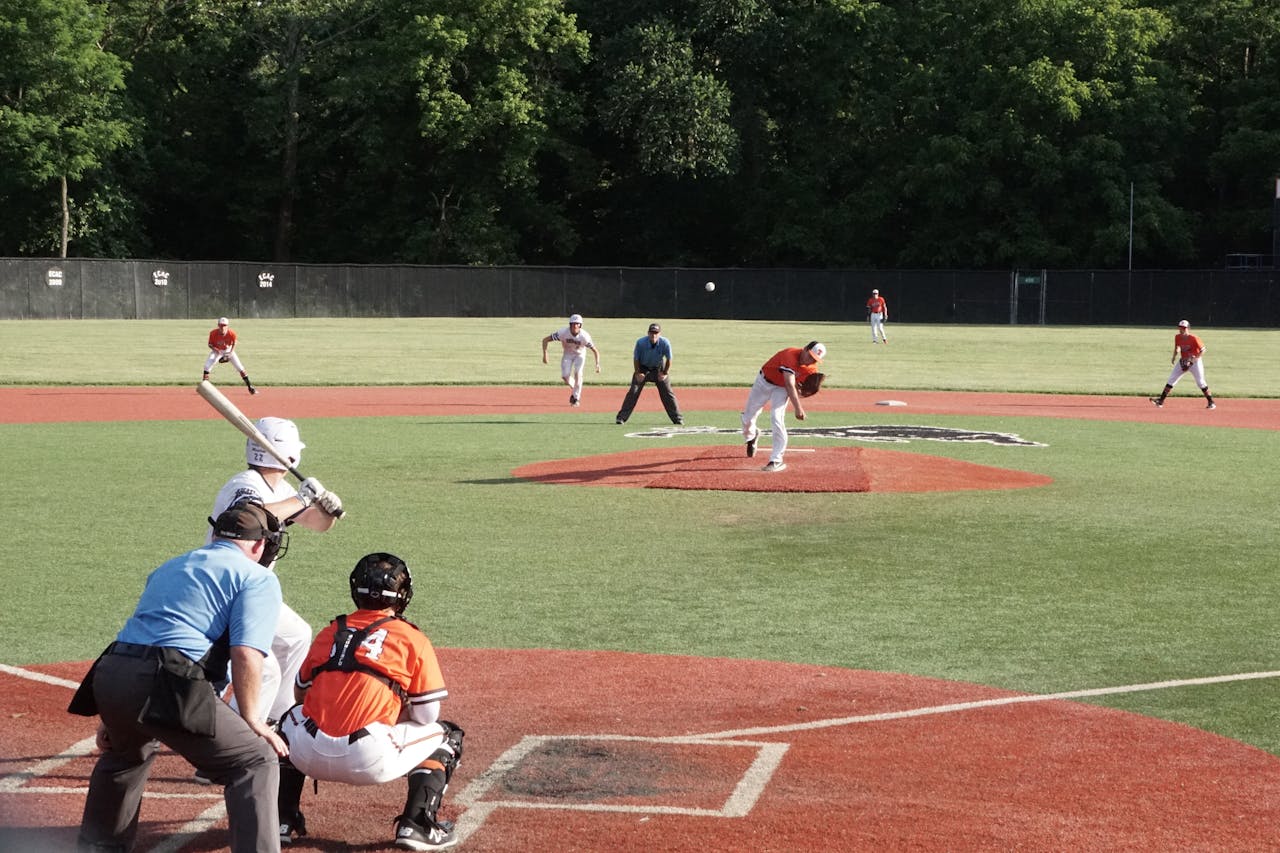 Exciting baseball match with players in motion, captured on a sunlit field.
